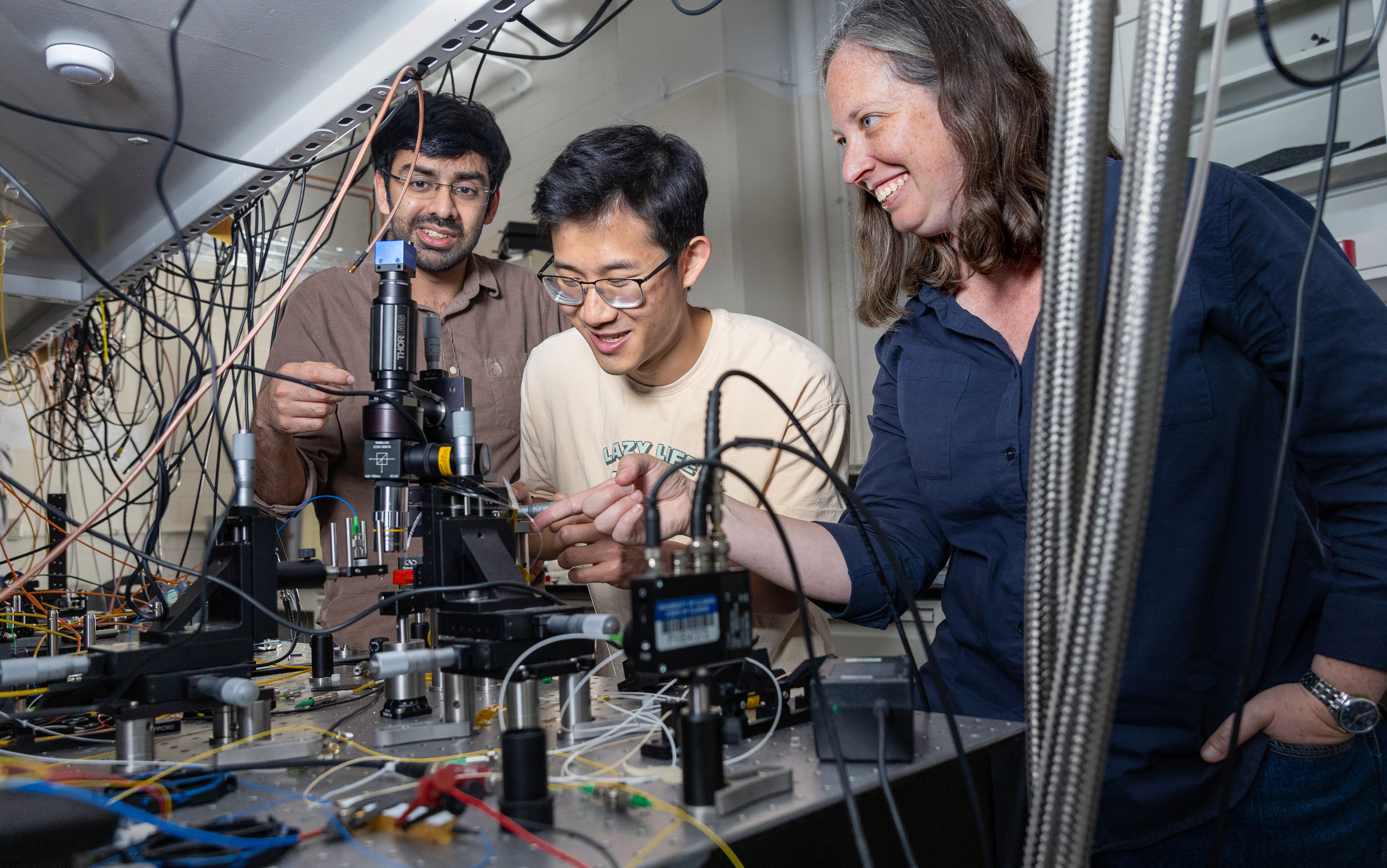 Priyash Barya, Darren Chen, and Elizabeth Goldschmidt in a lab.