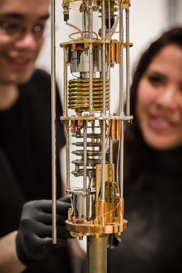 UIUC scientists working on dilution refrigerator in quantum lab.