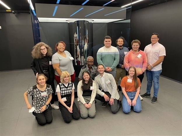 The entire 2022 OQI Undergraduate Fellowship cohort in front of the IBM quantum computer at IBM HQ New York.
