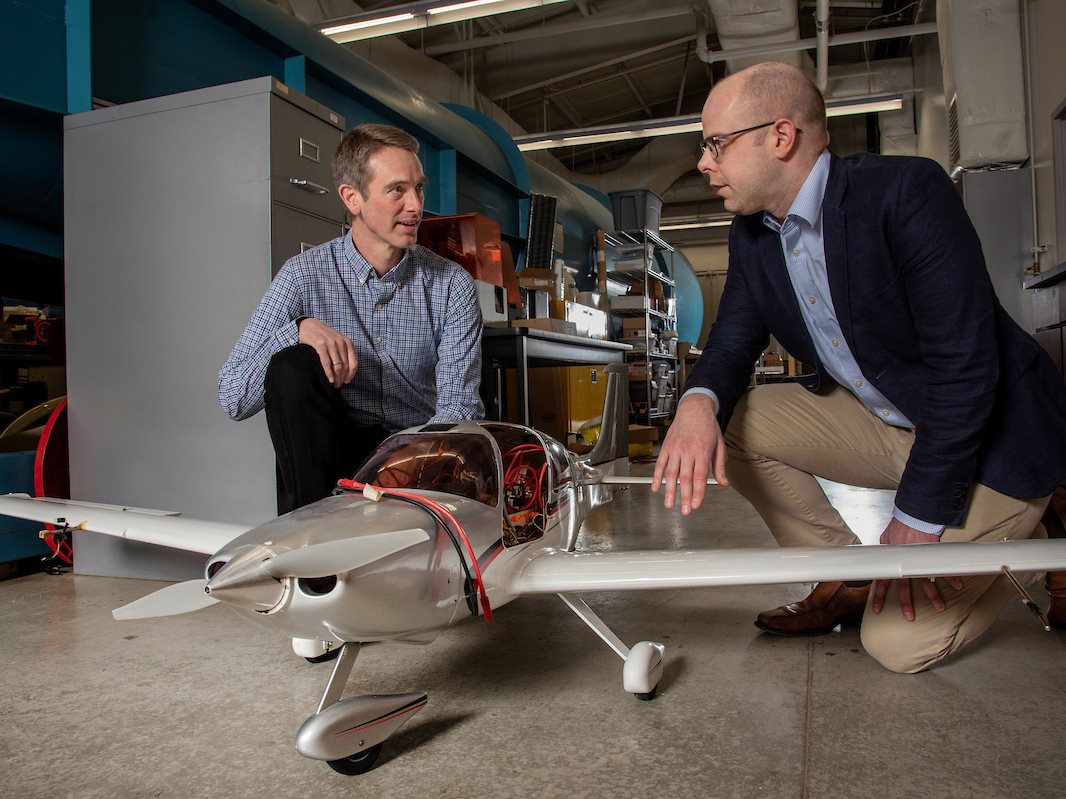 Aerospace professors with model airplane.