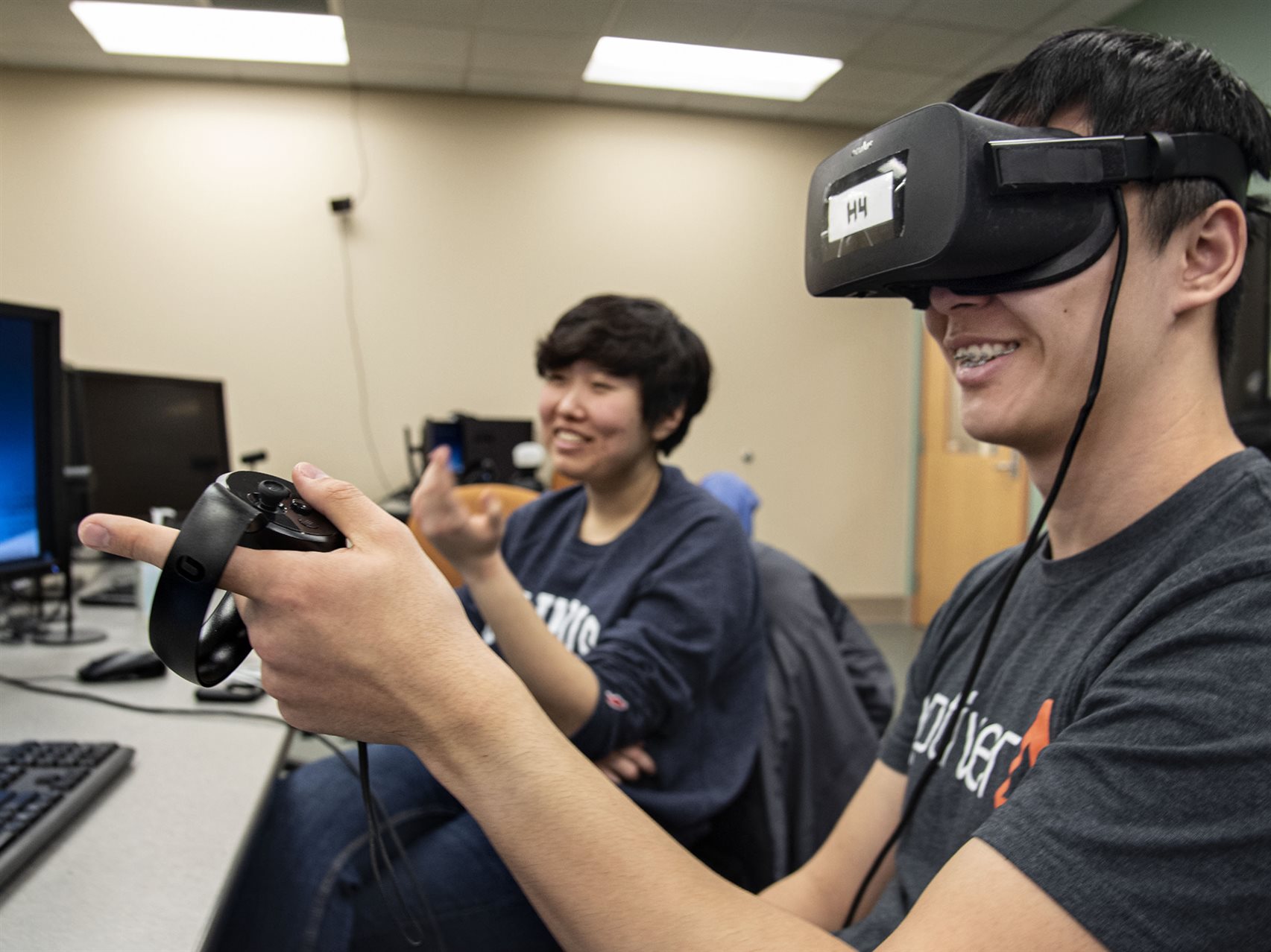 Students using VR headsets in computer lab.