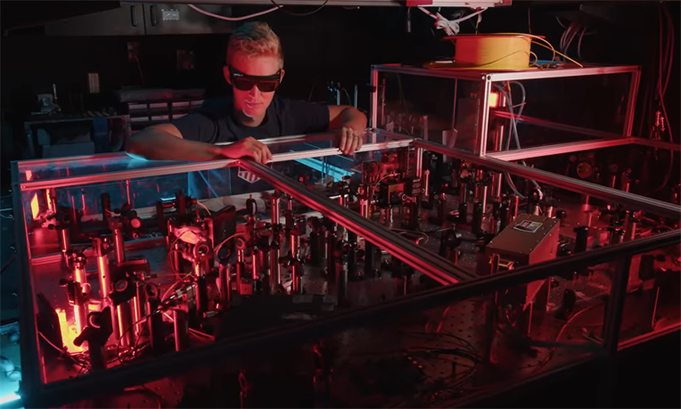 Man stands over quantum experiment